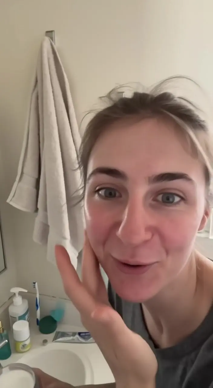 A woman filming a selfie in her bathroom mirror light, from Kling 4.0's first take